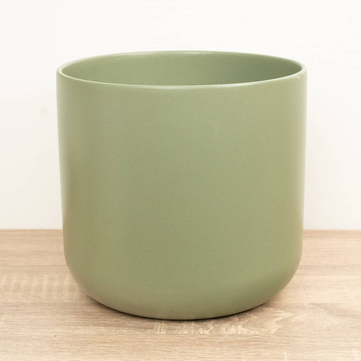 A single Sage Green Lisbon ceramic plant pot with a curved profile.